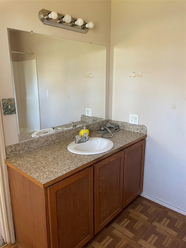 bathroom featuring vanity and parquet flooring