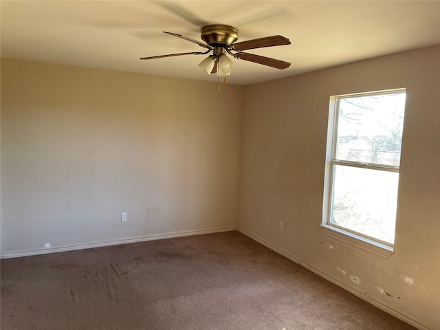 carpeted empty room featuring ceiling fan