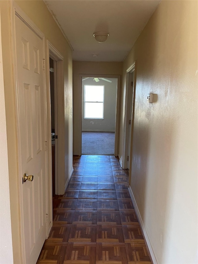 hallway with dark parquet floors