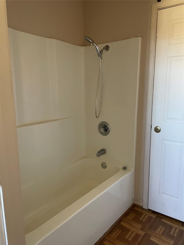 bathroom with parquet floors and tub / shower combination