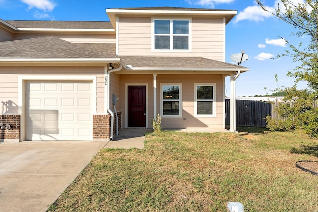 front facade with a garage and a front lawn