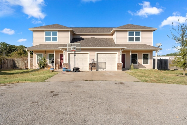 view of front of property with a garage, covered porch, and a front lawn