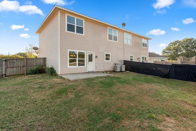 back of property with a yard, a patio area, and central air condition unit