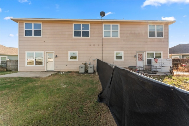 back of house with a yard and a patio