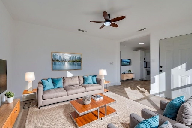 living room featuring ceiling fan and wood-type flooring