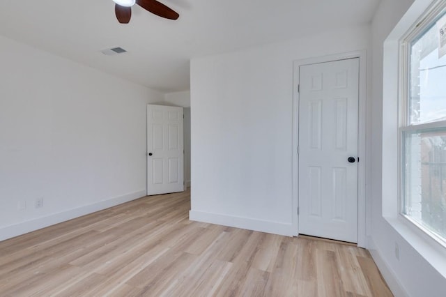 unfurnished bedroom featuring light wood-style floors, baseboards, visible vents, and ceiling fan