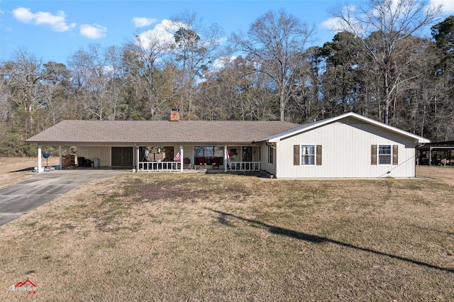 ranch-style home featuring a porch, a carport, and a front lawn