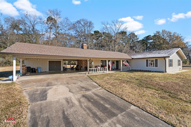 single story home featuring a porch, a garage, a carport, and a front yard