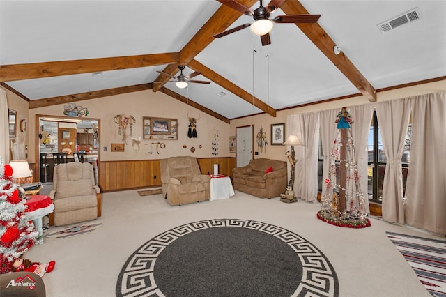 living room featuring vaulted ceiling with beams, ceiling fan, carpet flooring, and wood walls