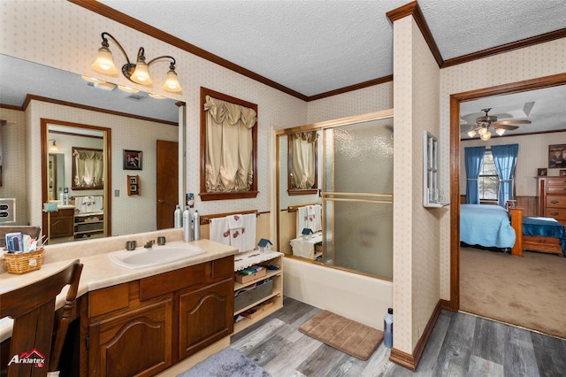 bathroom with vanity, wood-type flooring, enclosed tub / shower combo, and a textured ceiling