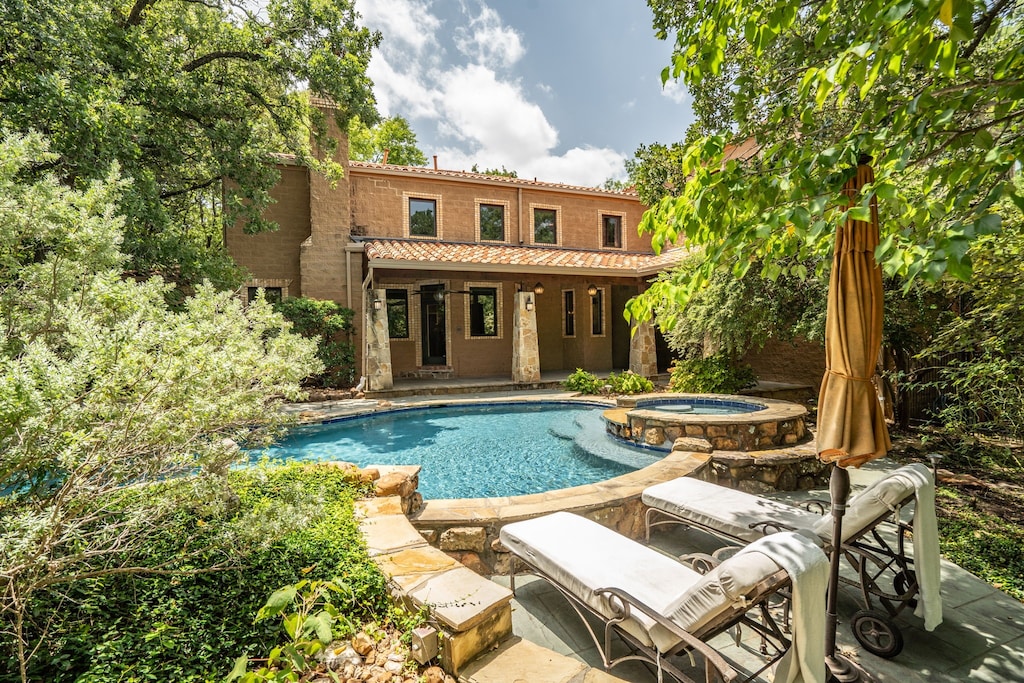 1097 E Hickory Hill Rd, Argyle, TX 76226 - view of swimming pool featuring an in ground hot tub, a patio area, and an outbuilding
