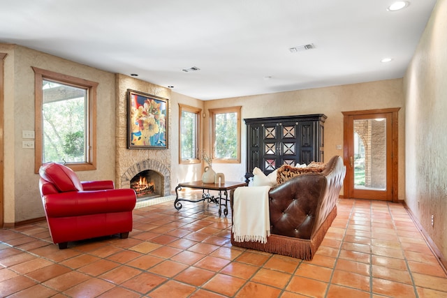 tiled living room with a fireplace