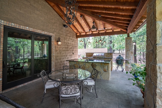 view of patio with exterior kitchen, a gazebo, and french doors