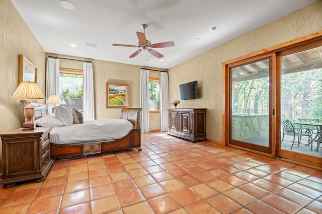 bedroom featuring multiple windows, access to exterior, light tile patterned floors, and ceiling fan