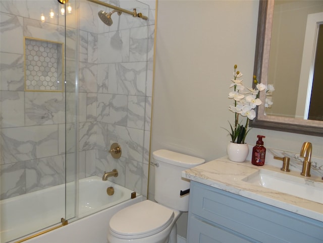 full bathroom with enclosed tub / shower combo, vanity, and toilet