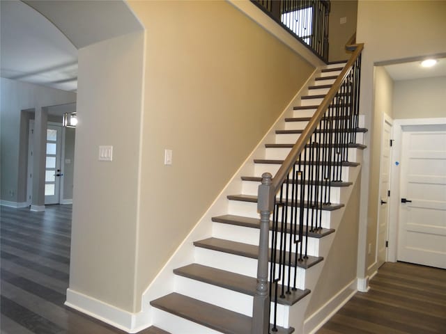 staircase featuring wood-type flooring