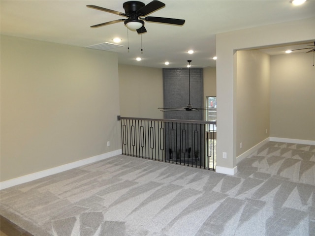 carpeted spare room with ceiling fan