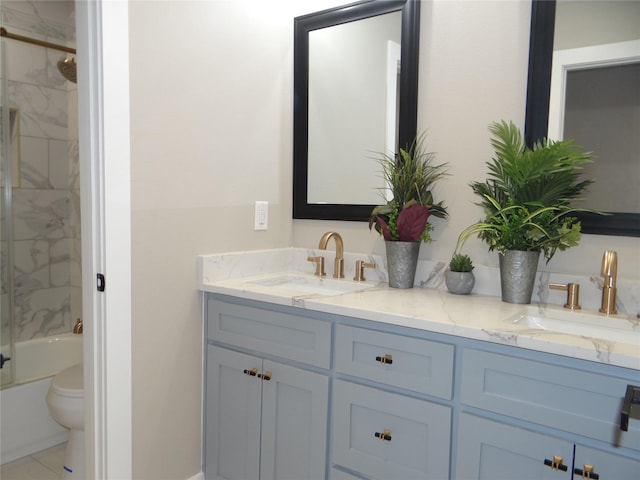 full bathroom featuring vanity, enclosed tub / shower combo, and toilet