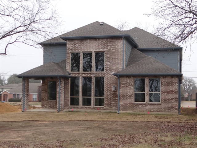 back of property with a patio