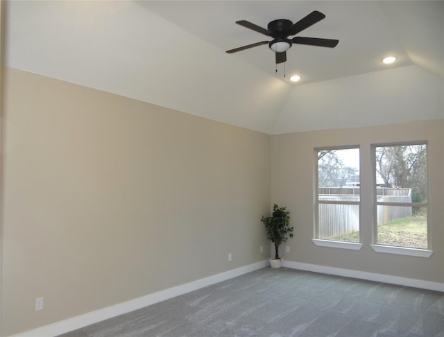 carpeted empty room featuring ceiling fan and vaulted ceiling