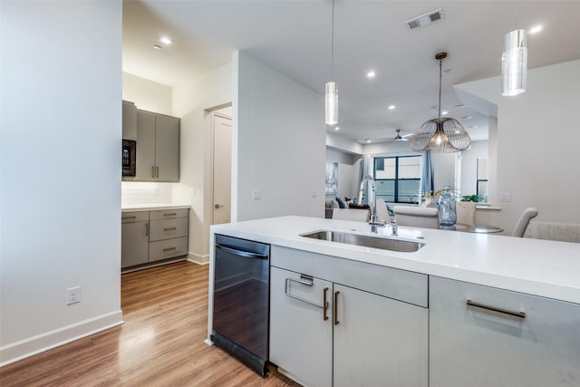 kitchen with pendant lighting, sink, gray cabinets, and black dishwasher