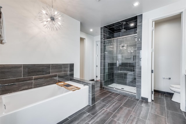 bathroom with separate shower and tub, an inviting chandelier, and toilet