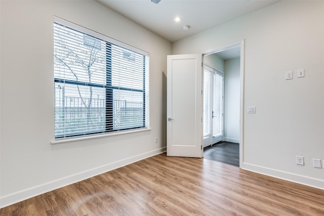 unfurnished room with light hardwood / wood-style flooring