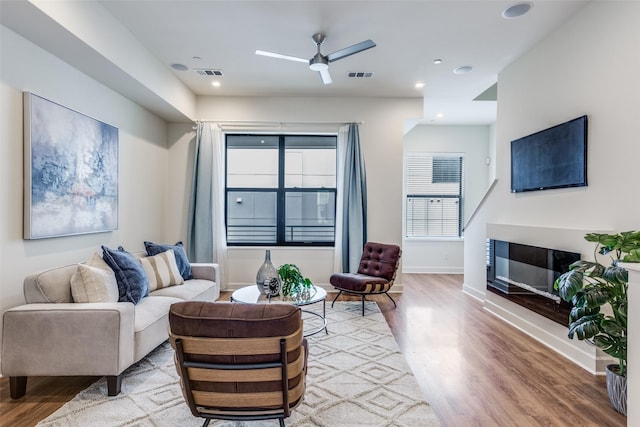 living room with hardwood / wood-style floors and ceiling fan