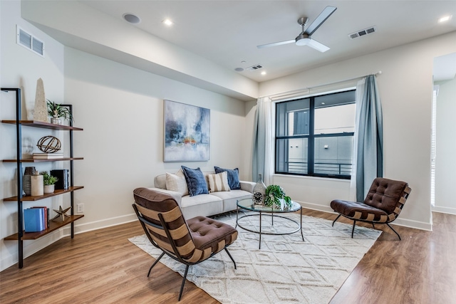 living room featuring ceiling fan and light wood-type flooring