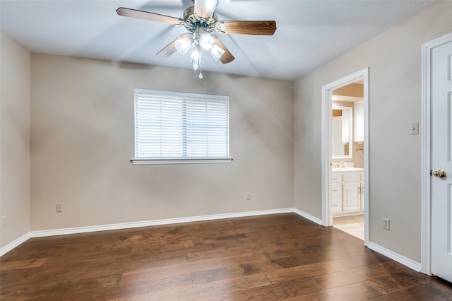 spare room with dark hardwood / wood-style floors and ceiling fan