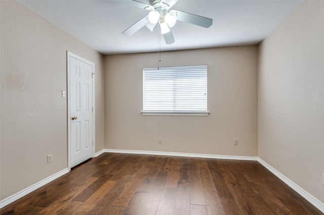 unfurnished room featuring dark wood-type flooring and ceiling fan