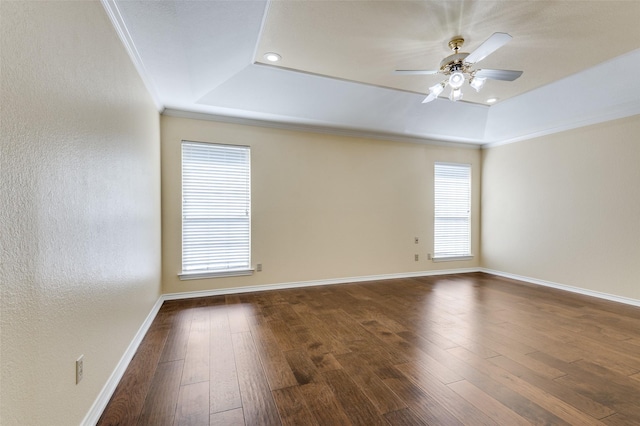 spare room with hardwood / wood-style flooring, a raised ceiling, ceiling fan, and crown molding