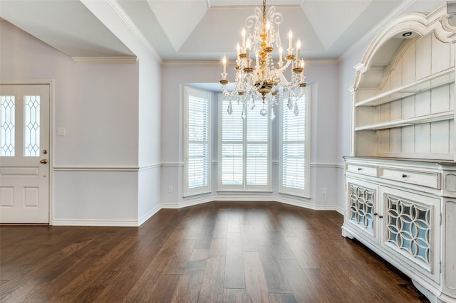 unfurnished dining area with lofted ceiling, an inviting chandelier, crown molding, a tray ceiling, and dark hardwood / wood-style floors