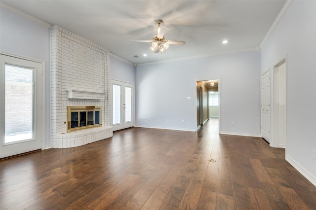 unfurnished living room with dark hardwood / wood-style floors, a healthy amount of sunlight, and a fireplace