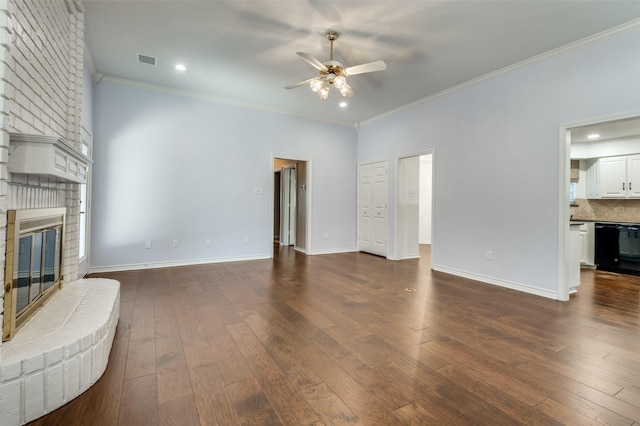 living room with crown molding, ceiling fan, dark hardwood / wood-style floors, and a brick fireplace