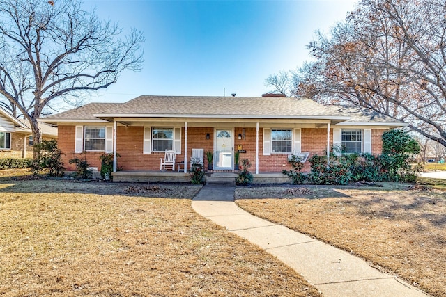 ranch-style home with a front yard and a porch