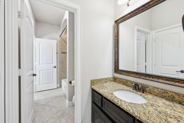 bathroom featuring vanity and tiled bath