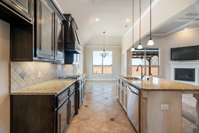 kitchen with lofted ceiling, sink, dark brown cabinetry, light stone counters, and stainless steel appliances