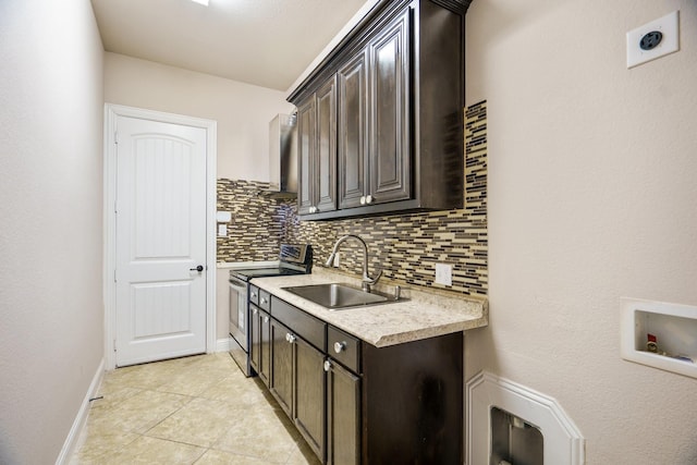 kitchen with light tile patterned flooring, sink, decorative backsplash, dark brown cabinets, and stainless steel electric range