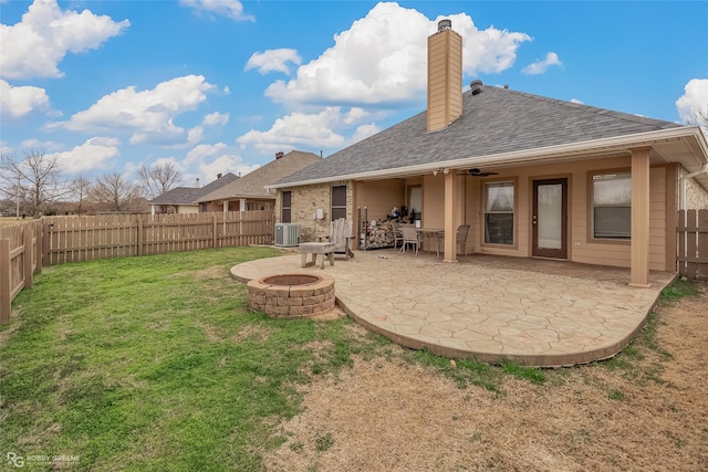 back of house featuring ceiling fan, a yard, central AC, a patio, and an outdoor fire pit