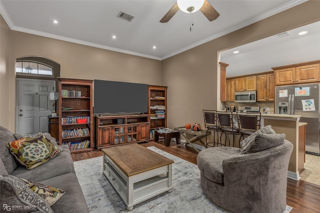 living room with crown molding, ceiling fan, and light wood-type flooring