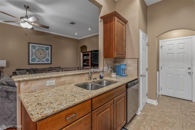 kitchen with sink, stainless steel dishwasher, light stone counters, and kitchen peninsula