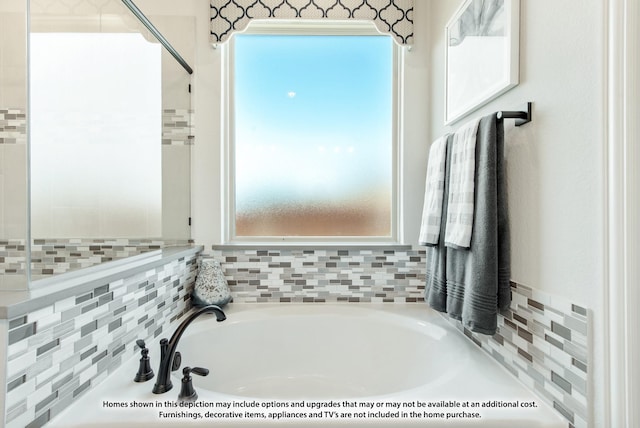 bathroom with plenty of natural light and a tub to relax in