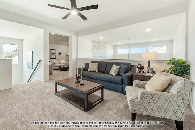 living room featuring light carpet and a healthy amount of sunlight