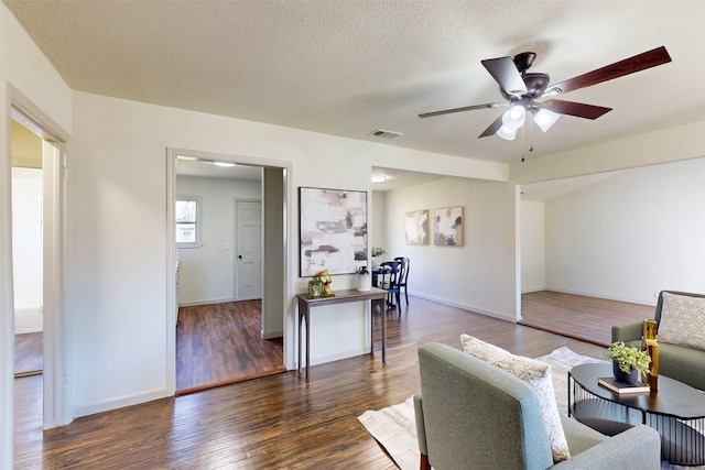 2842 Carlson Dr, Dallas, TX 75235 - living room with ceiling fan, a textured ceiling, and dark hardwood / wood-style flooring