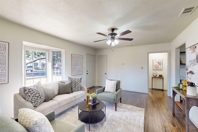 2842 Carlson Dr, Dallas, TX 75235 - living room featuring hardwood / wood-style floors, a textured ceiling, and ceiling fan