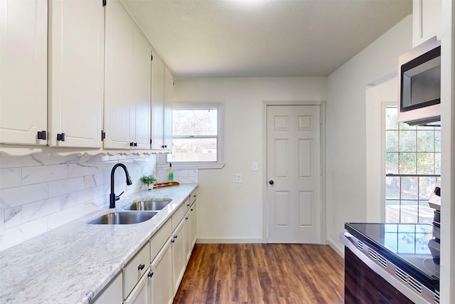 2842 Carlson Dr, Dallas, TX 75235 - kitchen with electric stove, sink, backsplash, dark hardwood / wood-style floors, and white cabinets