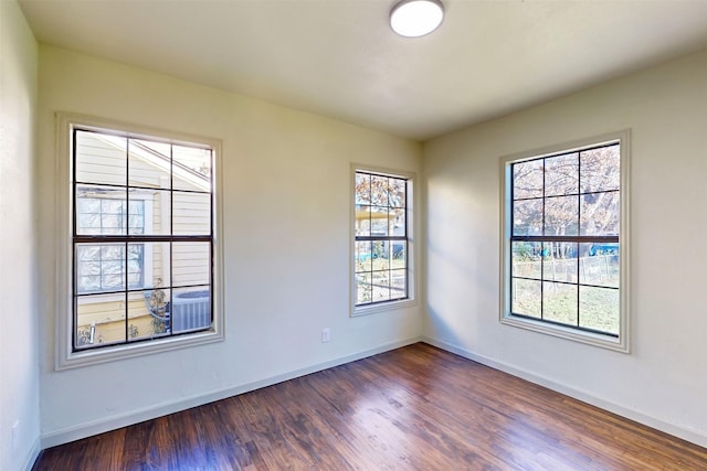 2842 Carlson Dr, Dallas, TX 75235 - unfurnished room with a healthy amount of sunlight and dark hardwood / wood-style floors