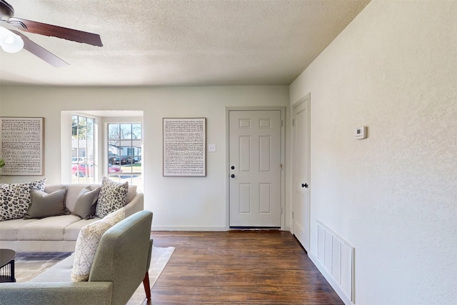 2842 Carlson Dr, Dallas, TX 75235 - living room featuring dark wood-type flooring, ceiling fan, and a textured ceiling