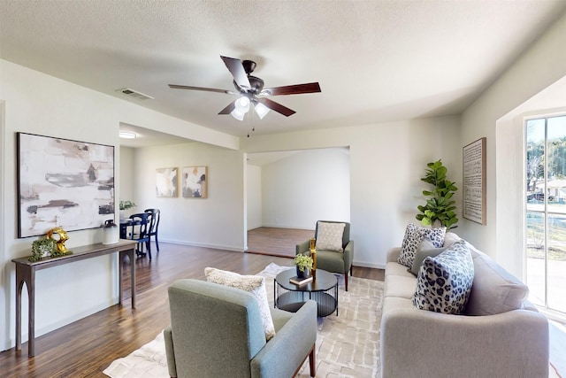 2842 Carlson Dr, Dallas, TX 75235 - living room with ceiling fan, hardwood / wood-style floors, and a textured ceiling